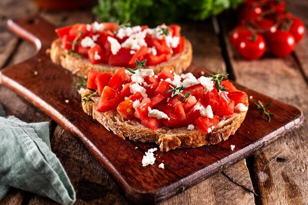 Mediterranean breakfast table with toast, tomatoes and olive oil