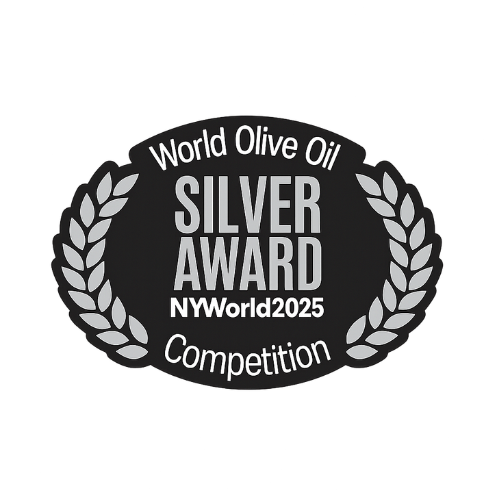 Olive oil award trophy and certificate next to a bottle of extra virgin olive oil