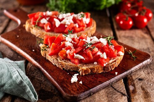 Mediterranean breakfast table with toast, tomatoes and olive oil